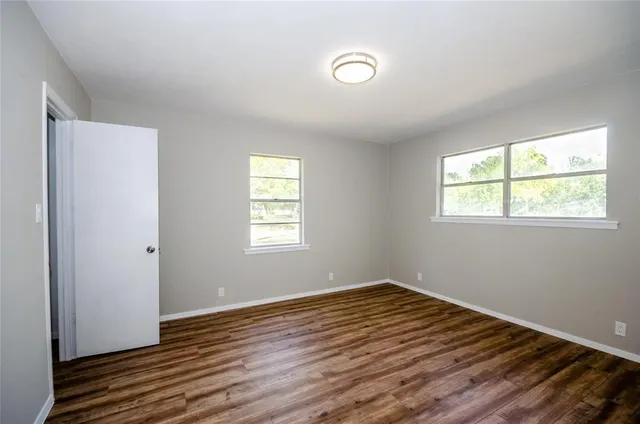 a view of hallway with wooden floor
