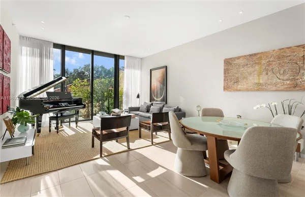 a living room with furniture and floor to ceiling windows