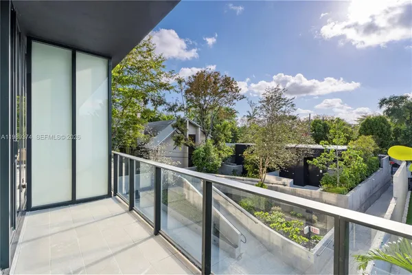 a balcony with wooden floor and outdoor seating