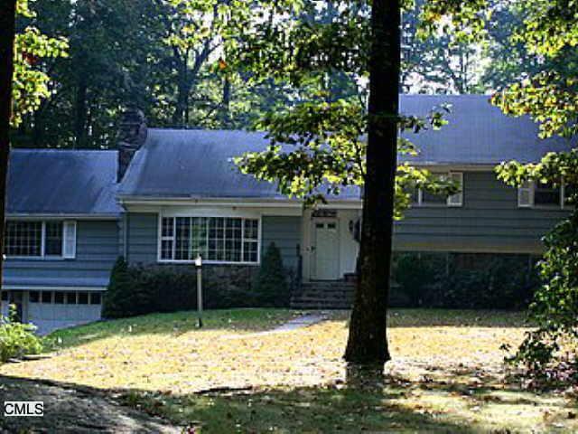 637 Rock Ridge Road Fairfield, CT 06824 - Photo 1 of 1 a front view of a house with a yard