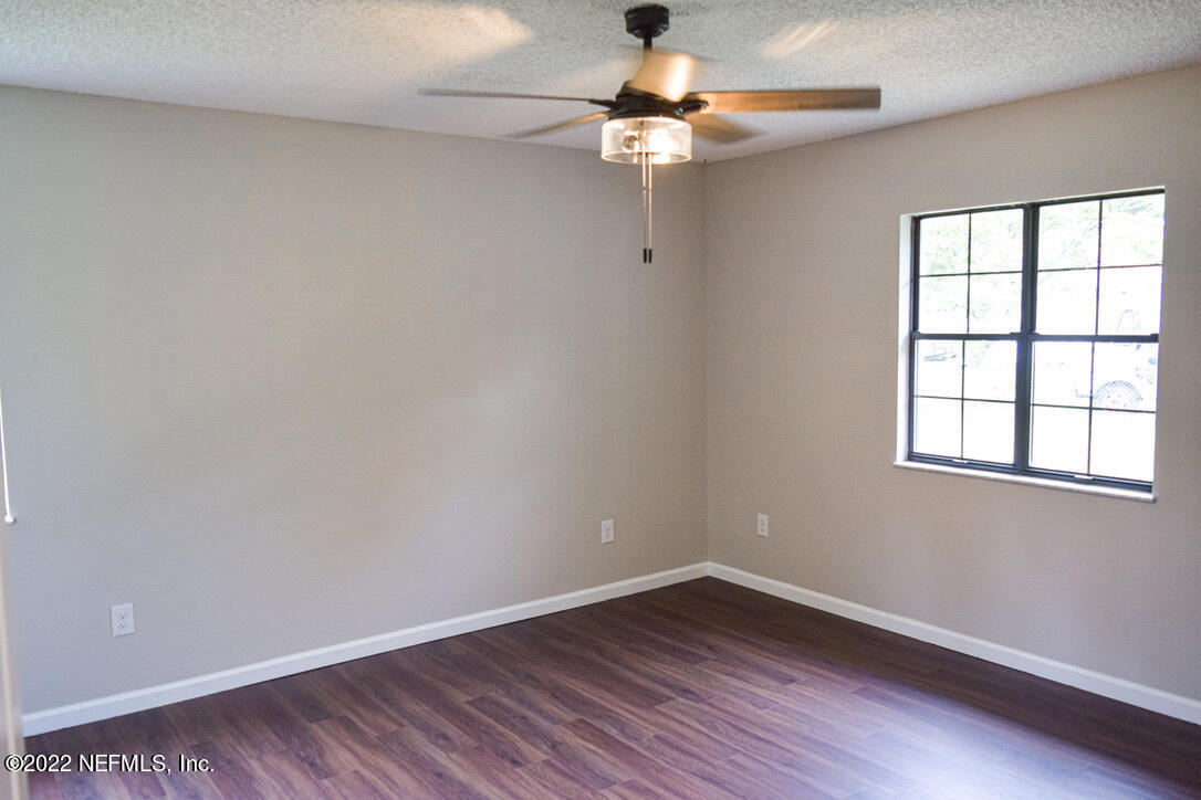 54608 Armstrong Road Callahan, FL 32011 - Photo 16 of 22 wooden floor in an empty room with a window