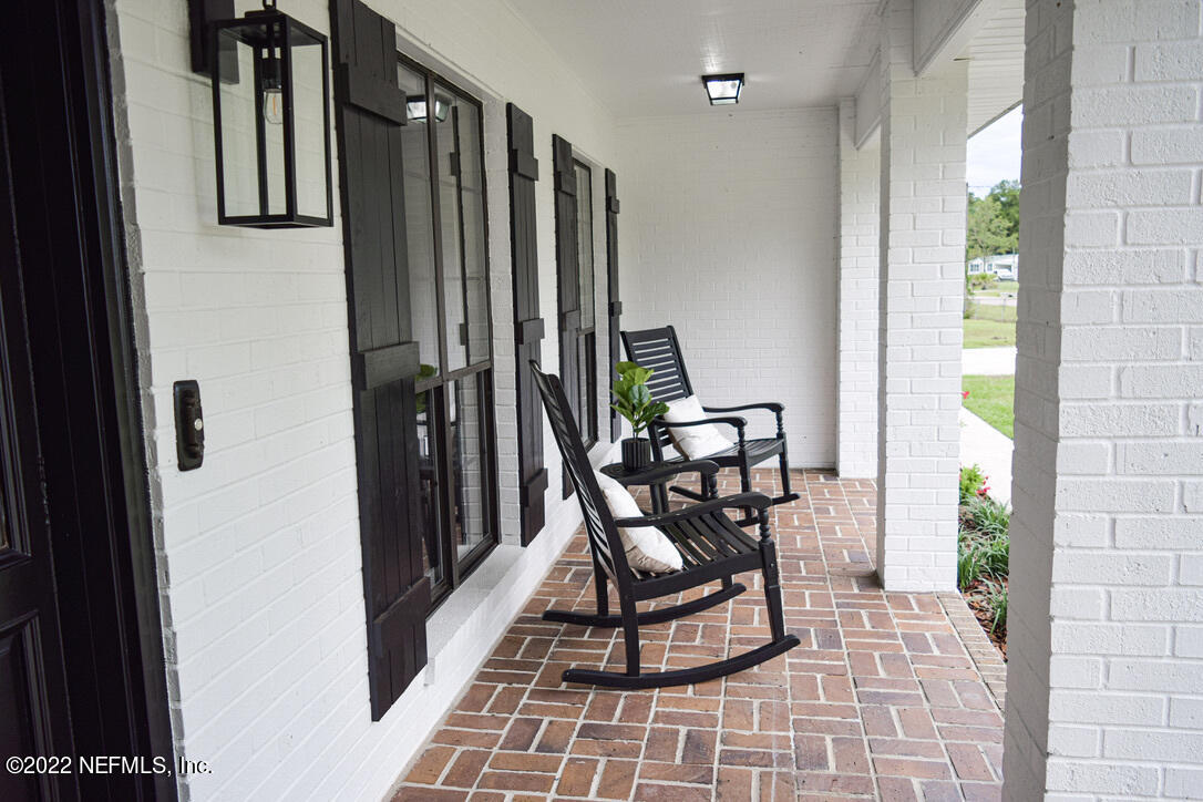 54608 Armstrong Road Callahan, FL 32011 - Photo 3 of 22 a view of a entryway with furniture and floor to ceiling window