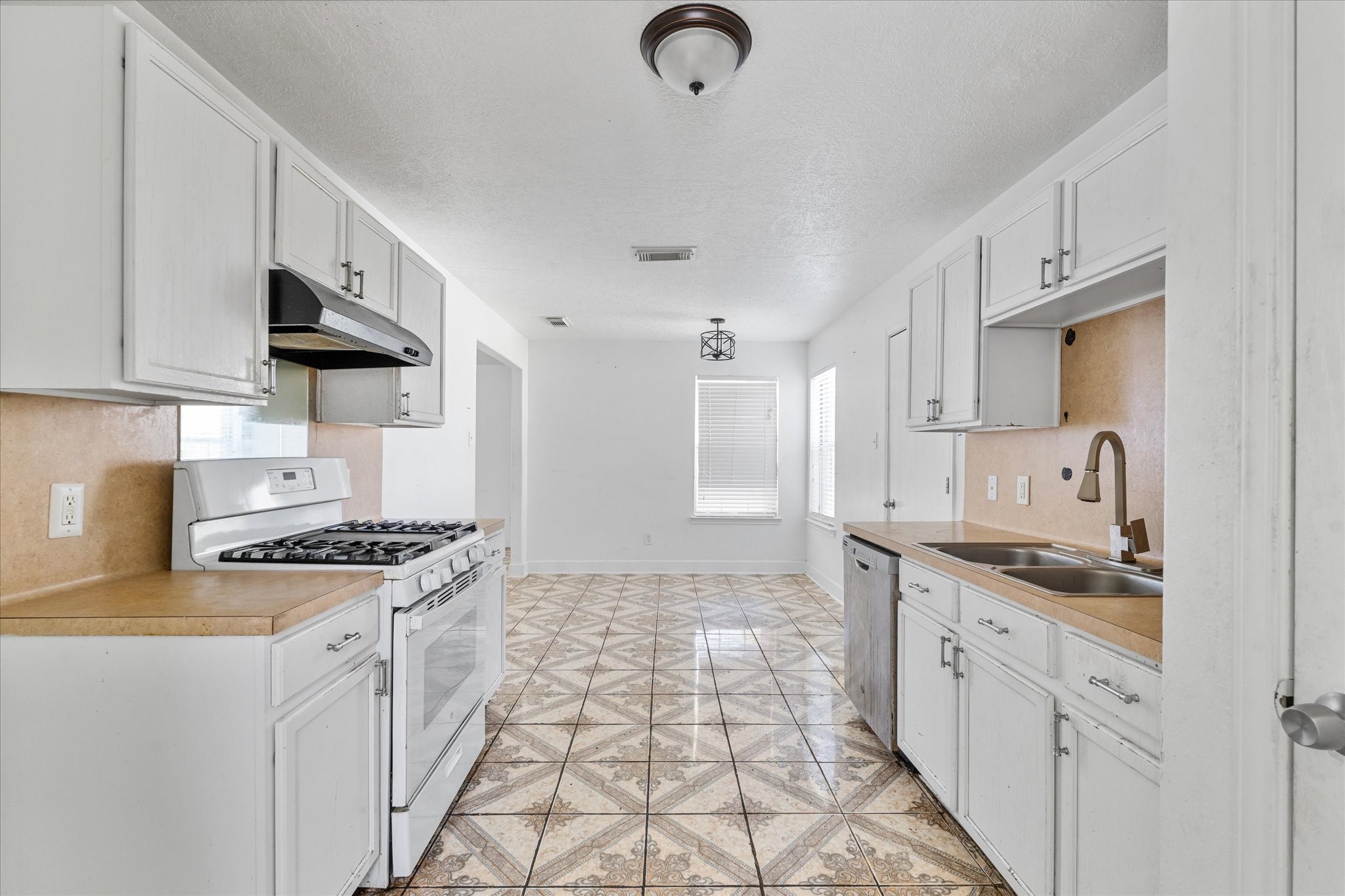 1410 Hade Falls Lane Houston, TX 77073 - Photo 12 of 25 a kitchen with granite countertop a sink stove and cabinets