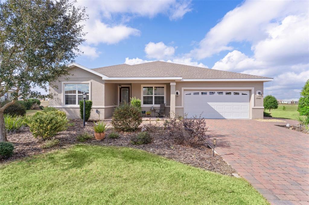 10061 Southwest 89th Loop Ocala, FL 34481 - Photo 1 of 1 a front view of house with yard and trees around