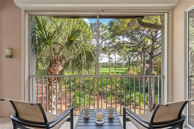 a view of a chairs and table in a balcony