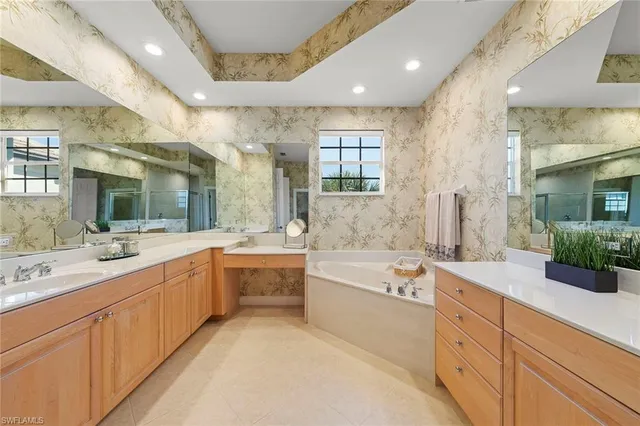 a large bathroom with a large tub and sink