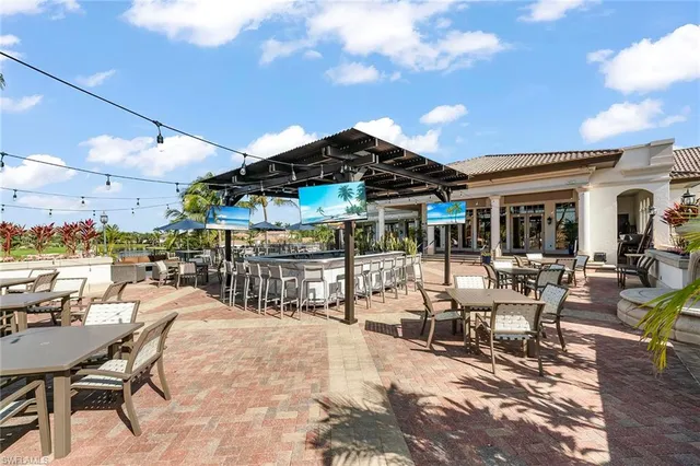 a view of a patio with dining table and chairs