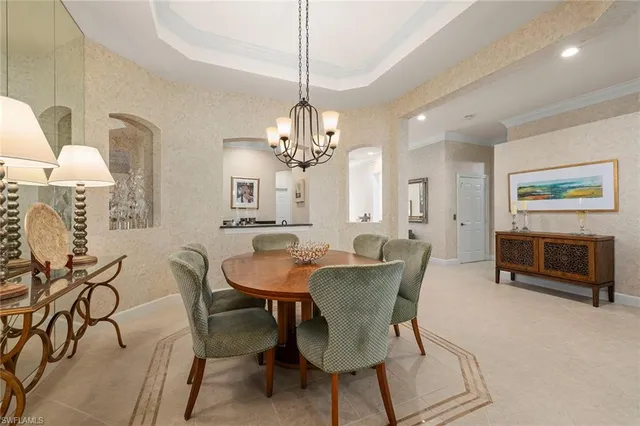 a view of a dining room with furniture and a chandelier