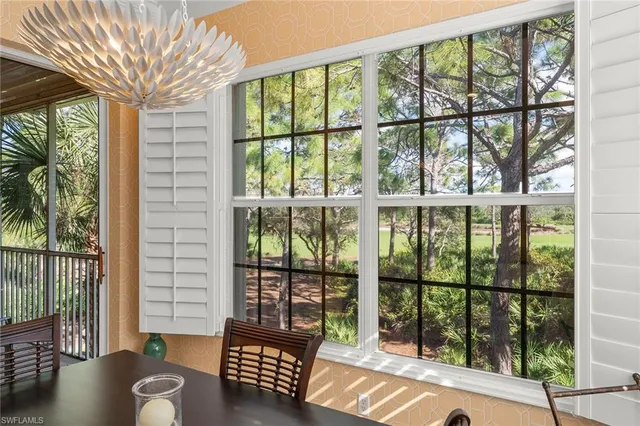 a living room filled with furniture and a large window