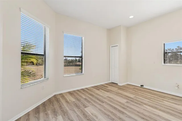 a view of a backyard with table and chairs under an umbrella