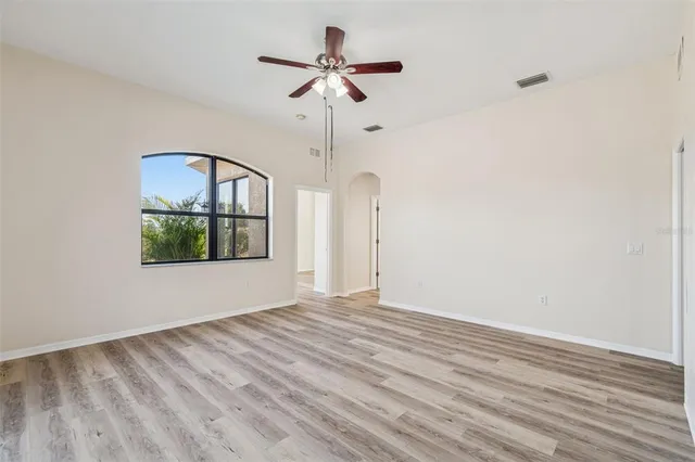 a front view of a house with a yard and trees