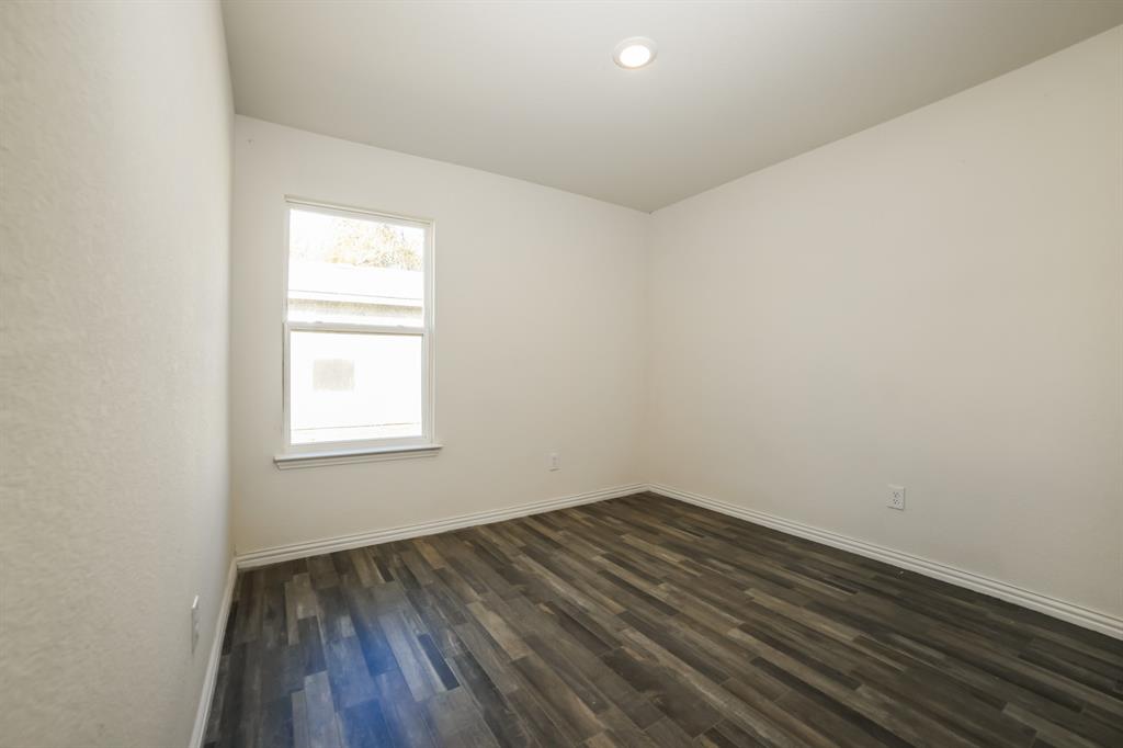 903 Olive Street Waco, TX 76704 - Photo 15 of 21 an empty room with wooden floor and windows