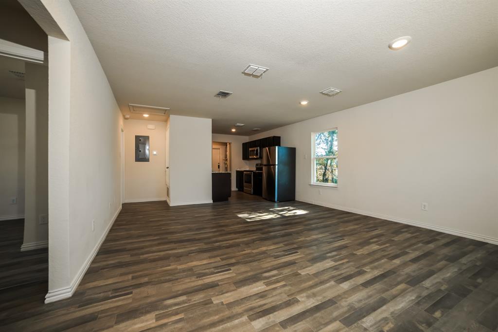 903 Olive Street Waco, TX 76704 - Photo 3 of 21 a view of an empty room and a kitchen