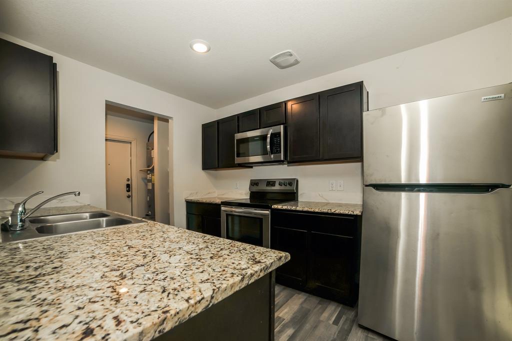 903 Olive Street Waco, TX 76704 - Photo 8 of 21 a kitchen with a refrigerator and a sink