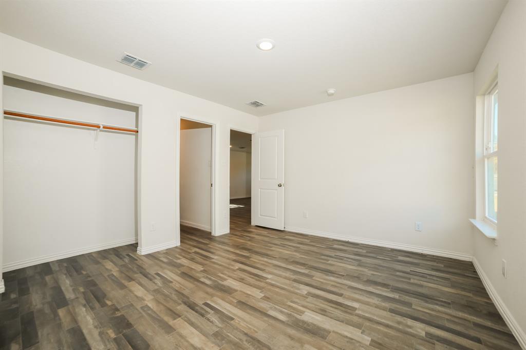 903 Olive Street Waco, TX 76704 - Photo 10 of 21 a view of an empty room with wooden floor and a window