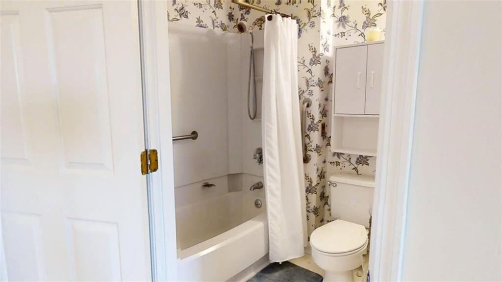 300 Johnson Ferry Road, Unit A1013 Atlanta, GA 30328 - Photo 2 of 18 a bathroom with a shower toilet and sink