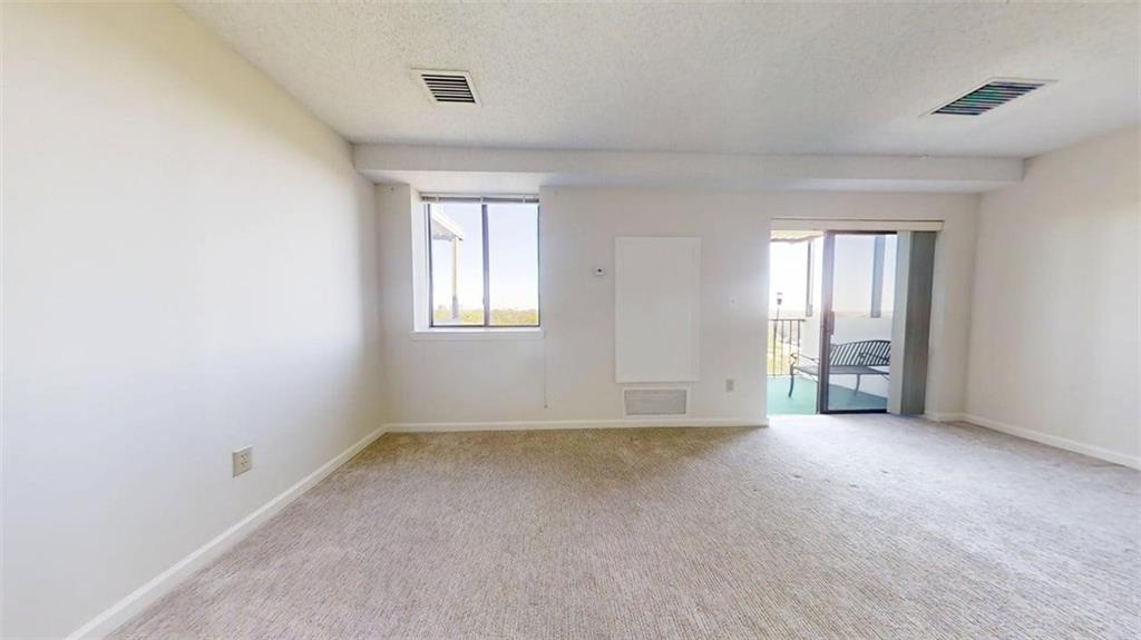 300 Johnson Ferry Road, Unit A1013 Atlanta, GA 30328 - Photo 9 of 18 an empty room with windows