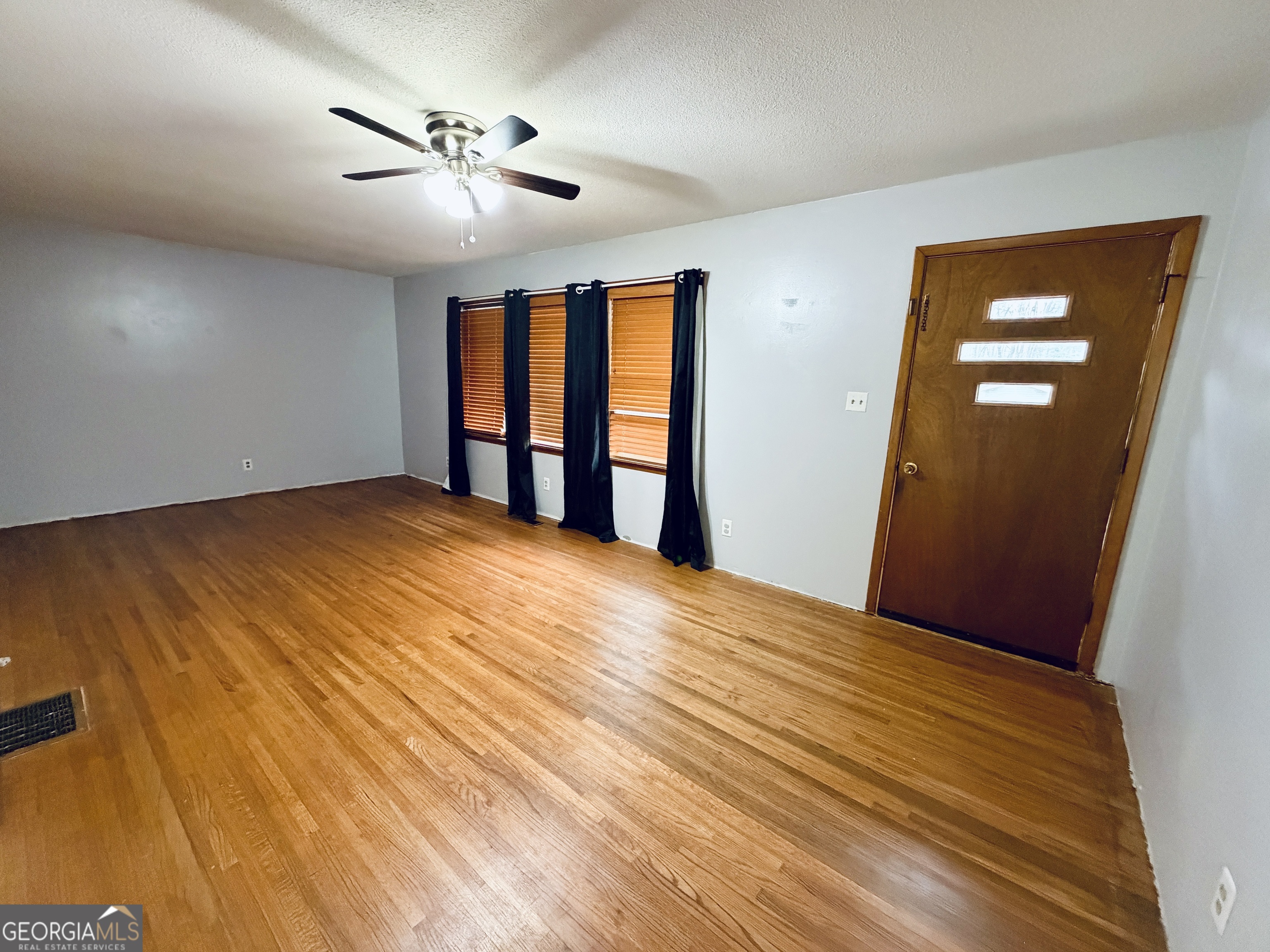 43 Sycamore Drive Toccoa, GA 30577 - Photo 2 of 22 a view of empty room with wooden floor and fan