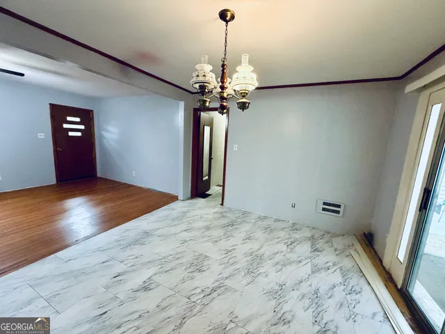 a view of a chandelier in big room and chandelier