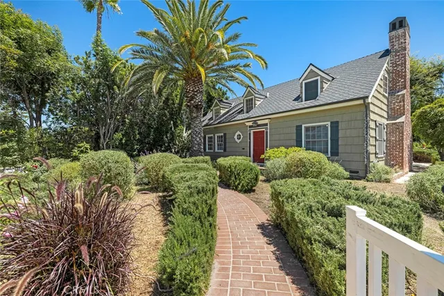 a dining room with furniture a fireplace and wooden floor