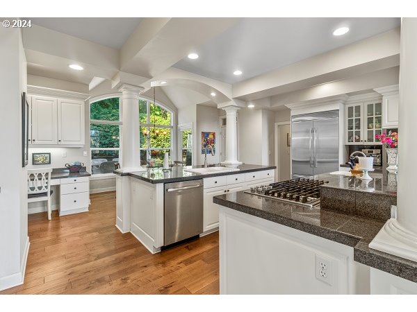 264 Southeast 41st Court Gresham, OR 97080 - Photo 17 of 37 a kitchen with stainless steel appliances granite countertop a stove a sink and a refrigerator