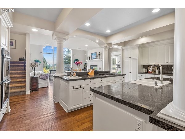 264 Southeast 41st Court Gresham, OR 97080 - Photo 18 of 37 a kitchen with stainless steel appliances granite countertop a sink a stove and a wooden floors