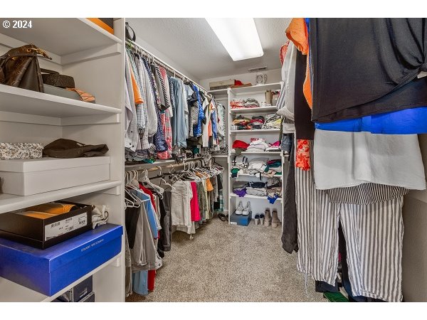 264 Southeast 41st Court Gresham, OR 97080 - Photo 27 of 37 a view of walk in closet with clothes and shoes