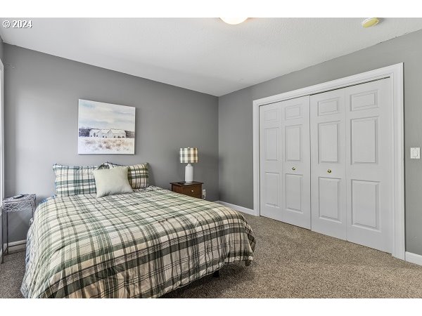 264 Southeast 41st Court Gresham, OR 97080 - Photo 29 of 37 a bedroom with a bed and a painting on the wall