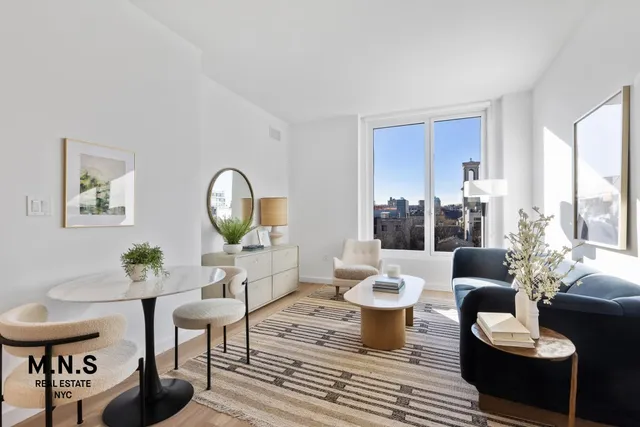 a living room with furniture a fireplace and a potted plant