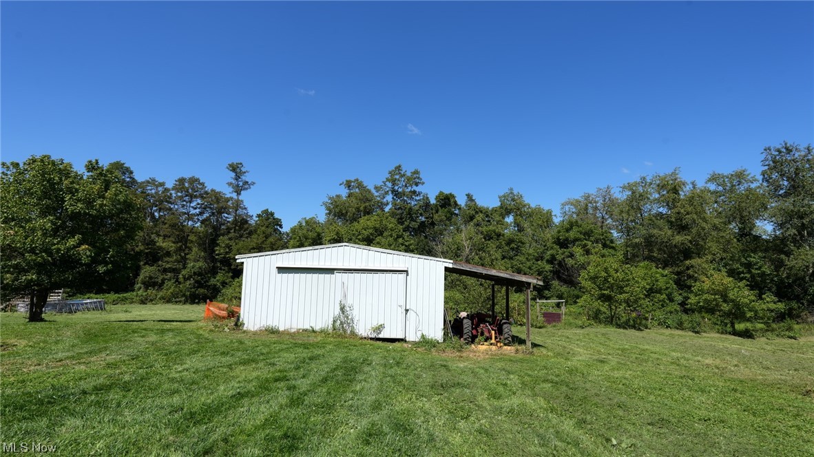70871 Angus Road Cambridge, OH 43725 - Photo 7 of 29 View of shed / structure with a storage shed and a lawn