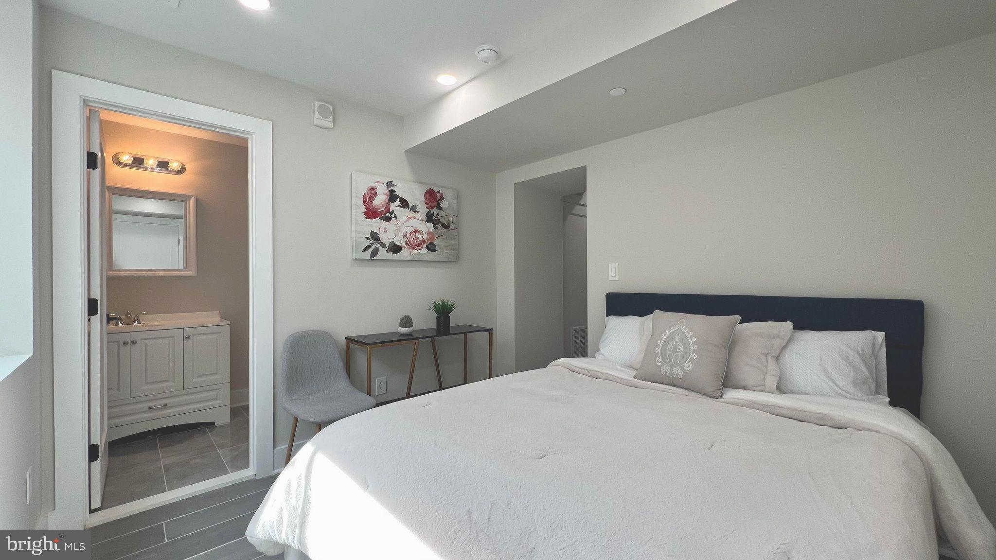 824 18th Street Northeast, Unit 1 Washington, DC 20002 - Photo 12 of 21 a bedroom with a bed and a view of bathroom