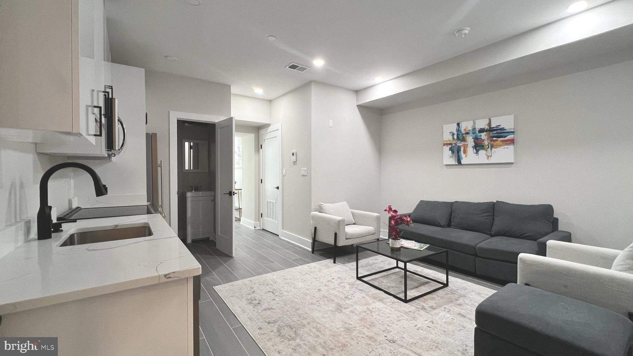 824 18th Street Northeast, Unit 1 Washington, DC 20002 - Photo 2 of 21 a living room with furniture and kitchen