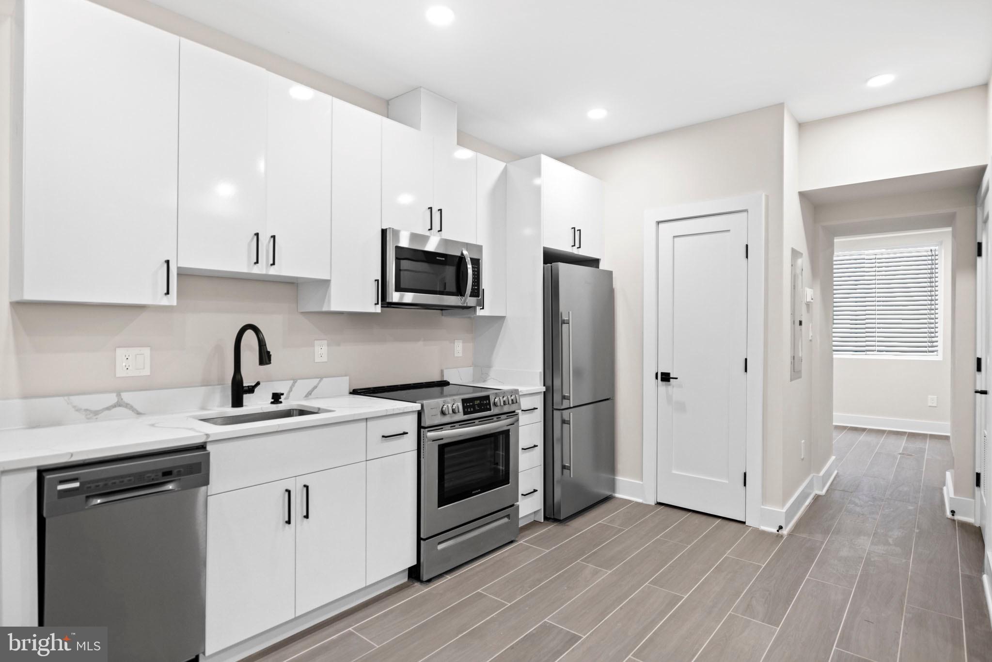 824 18th Street Northeast, Unit 1 Washington, DC 20002 - Photo 3 of 21 a kitchen with stainless steel appliances a sink cabinets and a refrigerator