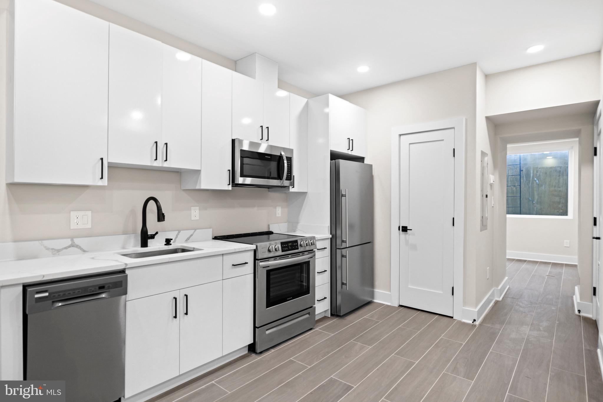 824 18th Street Northeast, Unit 1 Washington, DC 20002 - Photo 8 of 21 a kitchen with stainless steel appliances a sink cabinets and a refrigerator