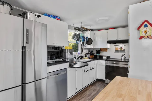 a kitchen with stainless steel appliances a stove refrigerator sink and cabinets