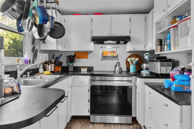 a kitchen with a stove and cabinets