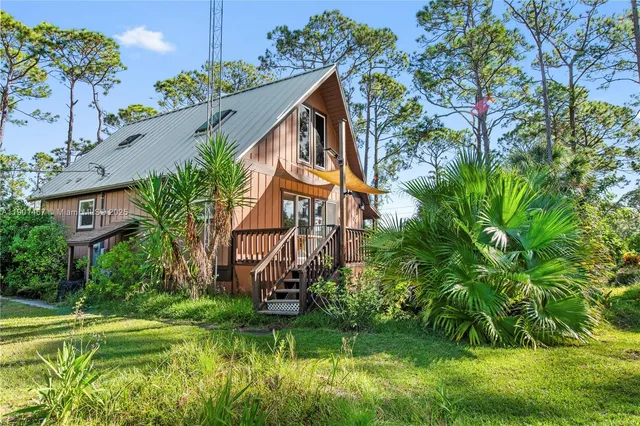 a view of a house with a yard and plants