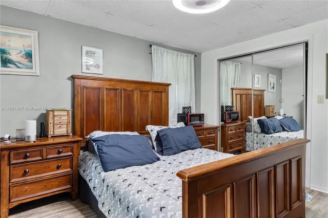 a bedroom with two beds and a dresser