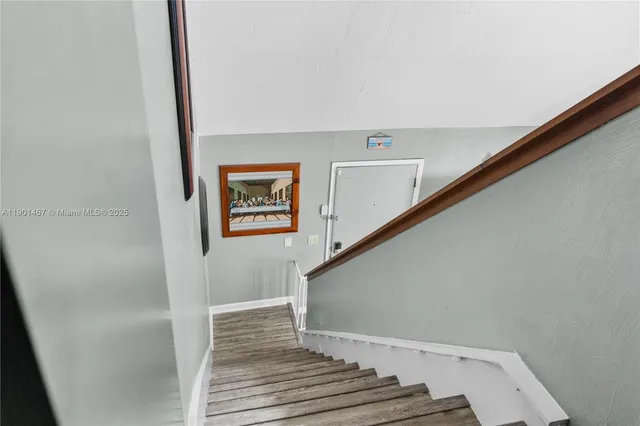 a view of staircase with wooden floor