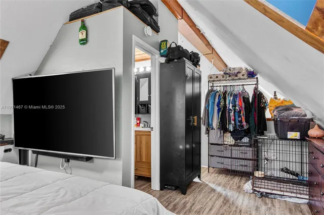 a bedroom with a bed and a television