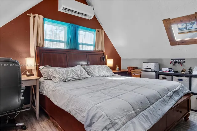 a bedroom with a bed a dresser and a window