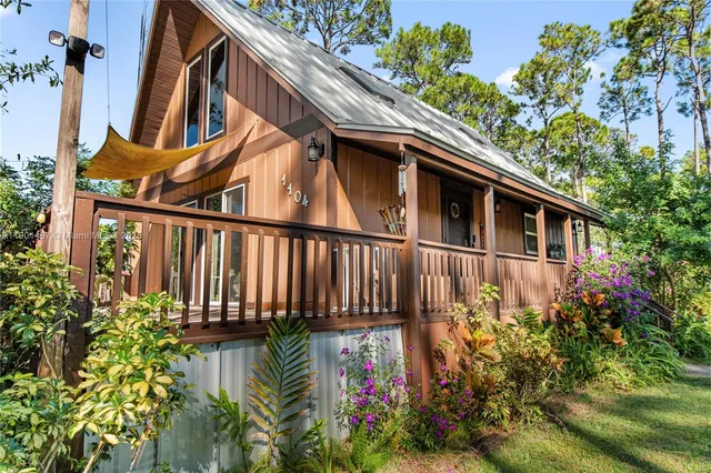 a view of a house with wooden fence
