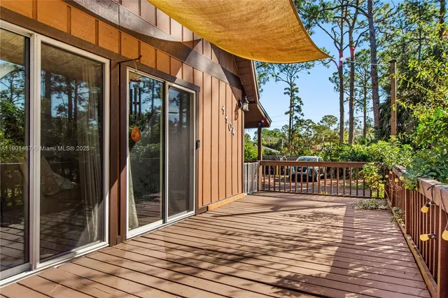 a balcony of a house with wooden floor and fence
