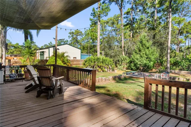 a view of a chairs and table on the wooden deck