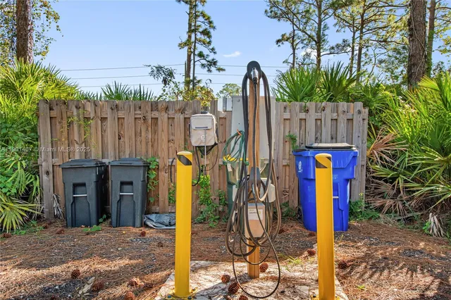a view of a backyard with wooden fence