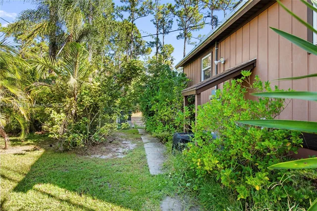 a view of a house with a yard and plants