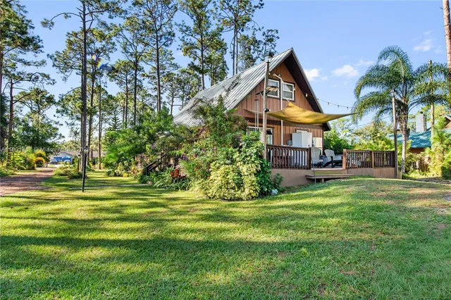 a front view of a house with a yard table and chairs