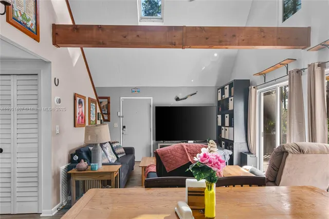 a living room with furniture and flowers
