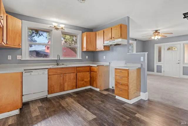 a kitchen with a sink cabinets and window