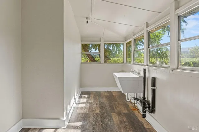 a view of a room with wooden floor and windows